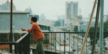 man on city balcony